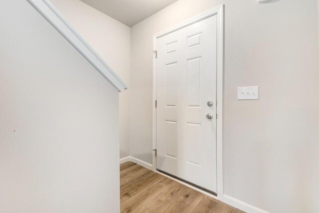 doorway with light wood-type flooring