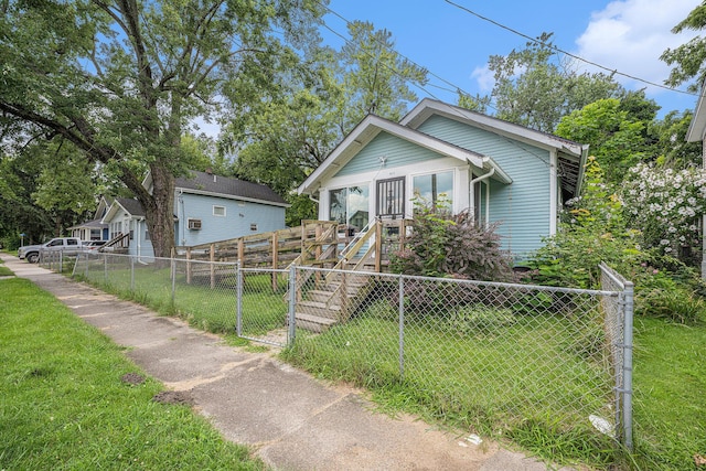 bungalow-style home with a front lawn