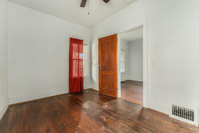 spare room with ceiling fan and dark hardwood / wood-style flooring