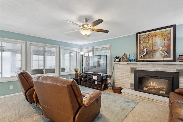 carpeted living room with ceiling fan and a fireplace