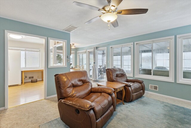 living room with light carpet and ceiling fan