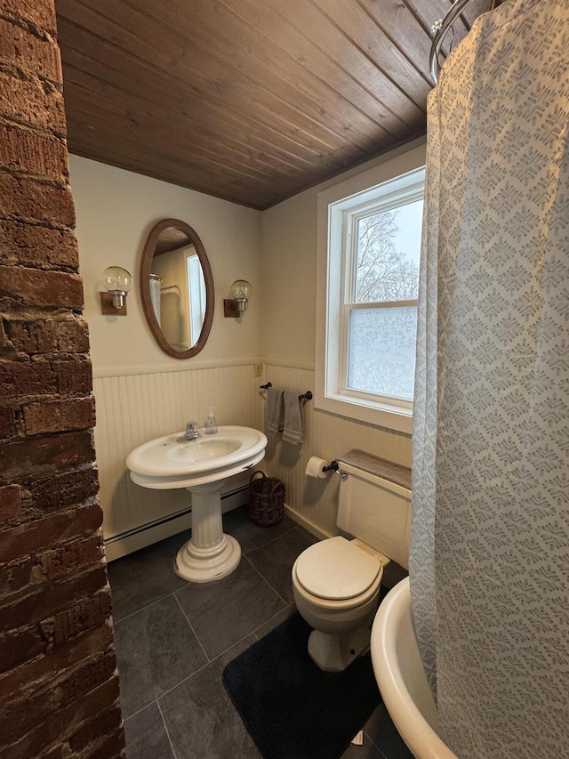 bathroom featuring a baseboard heating unit, sink, tile patterned flooring, toilet, and wood ceiling