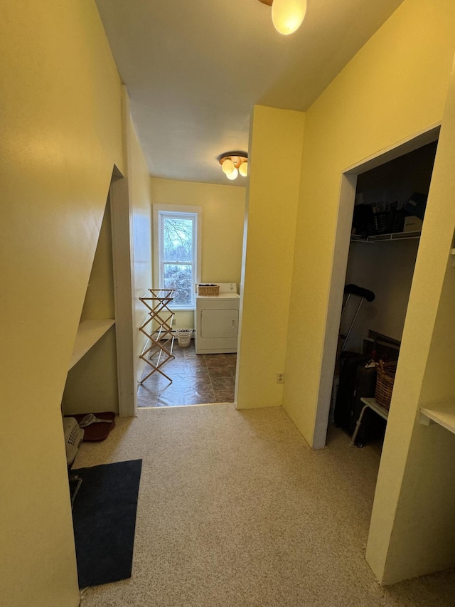 corridor featuring carpet flooring and washer / dryer