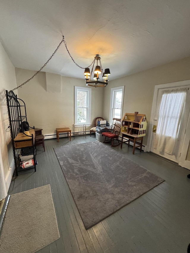 living area with a chandelier, hardwood / wood-style flooring, and a baseboard radiator