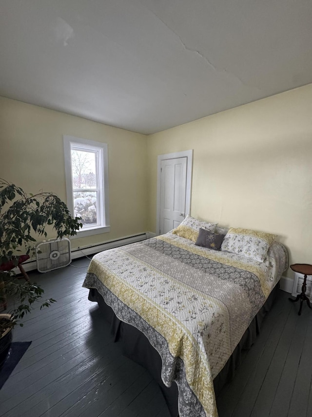 bedroom with a closet, dark wood-type flooring, and a baseboard radiator