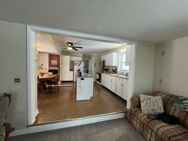 kitchen with white cabinetry, sink, ceiling fan, kitchen peninsula, and white appliances