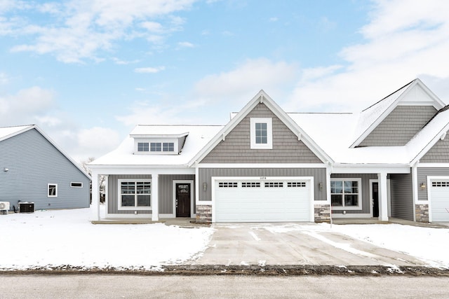 craftsman-style house featuring a garage and central AC