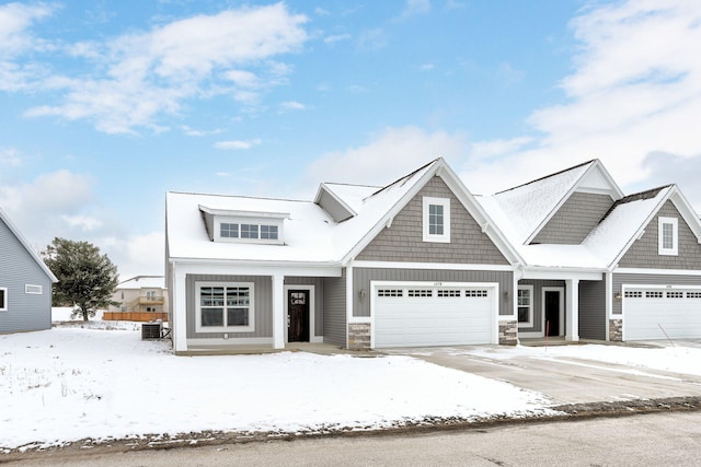 view of front of house with cooling unit and a garage