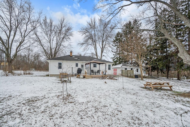 snow covered property with a wooden deck