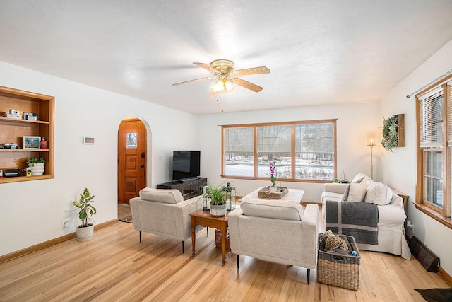 living room with light hardwood / wood-style floors, plenty of natural light, and ceiling fan