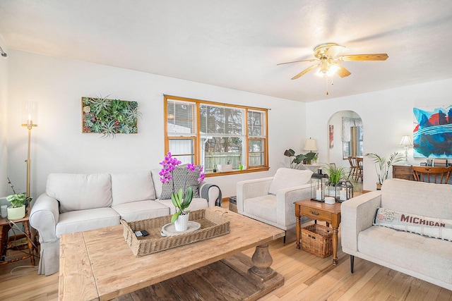 living room with ceiling fan and light wood-type flooring