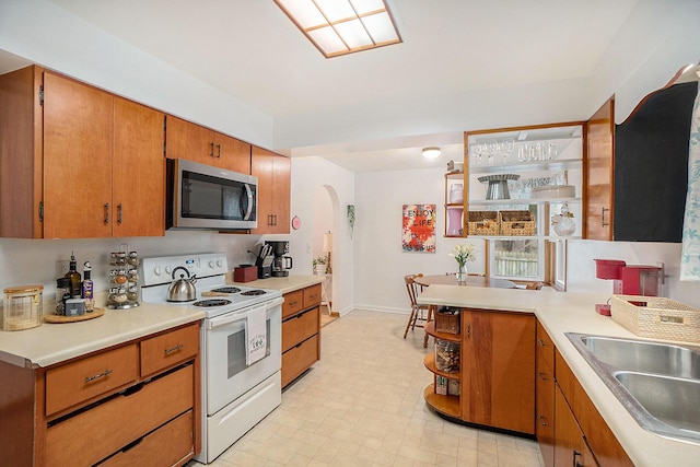 kitchen with white range with electric cooktop and sink