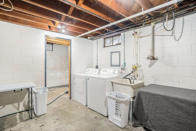 laundry room with separate washer and dryer and sink