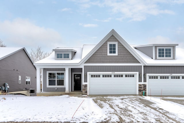 view of front facade with central AC and a garage