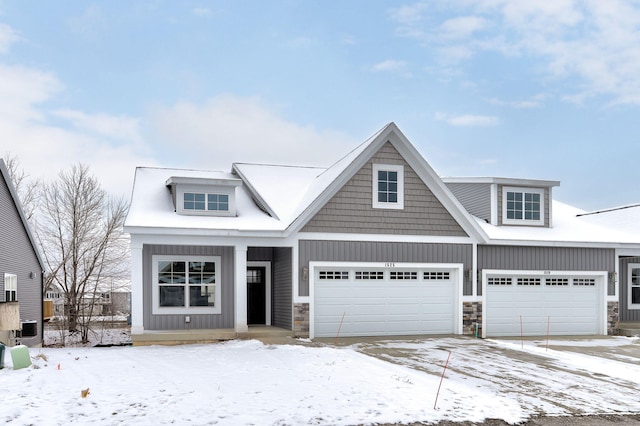 view of front of property featuring a garage and central AC