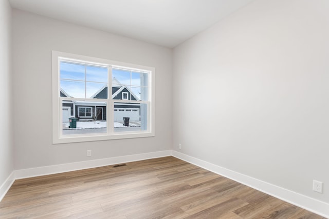 unfurnished room with light wood-type flooring