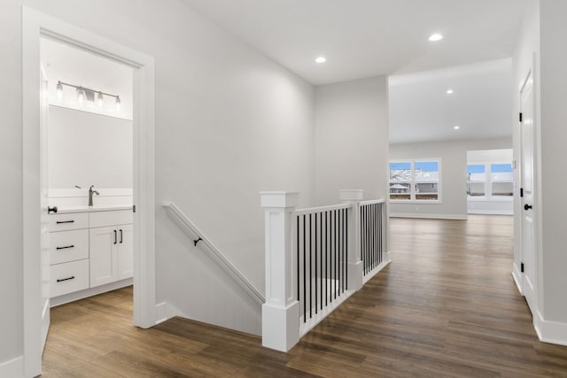 hall with dark hardwood / wood-style flooring and sink