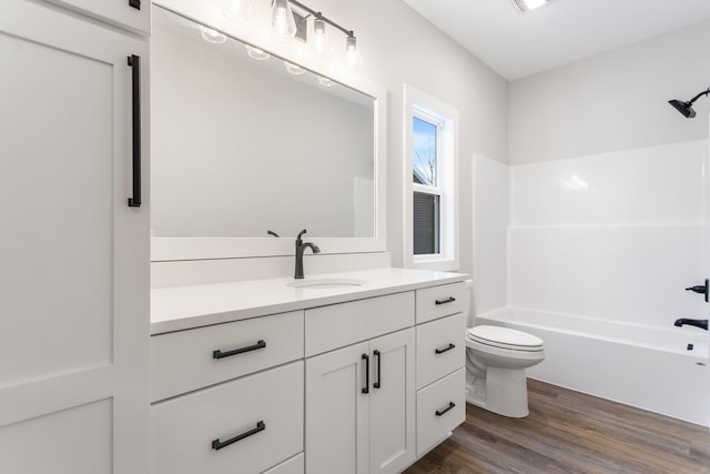 full bathroom with toilet, vanity, shower / bathtub combination, and hardwood / wood-style flooring