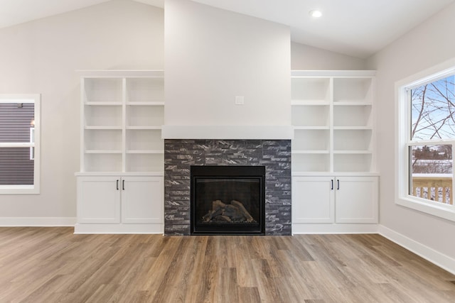 unfurnished living room with light hardwood / wood-style floors and vaulted ceiling