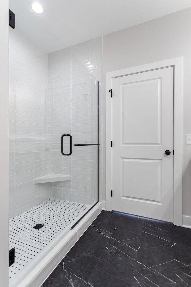 bathroom with a shower with shower door