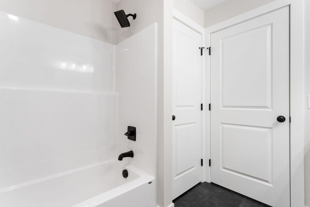 bathroom with tile patterned flooring and shower / bathtub combination