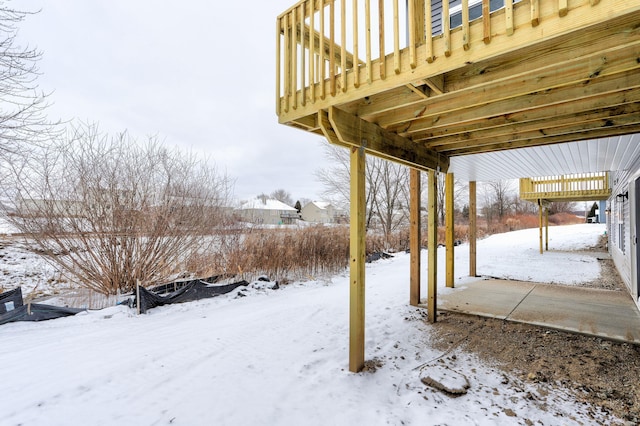 yard covered in snow featuring a deck