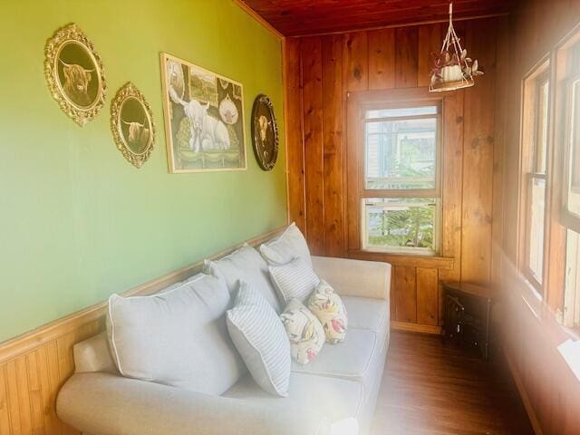 living room featuring hardwood / wood-style floors and wooden walls