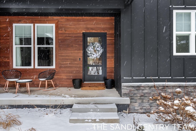 view of snow covered property entrance