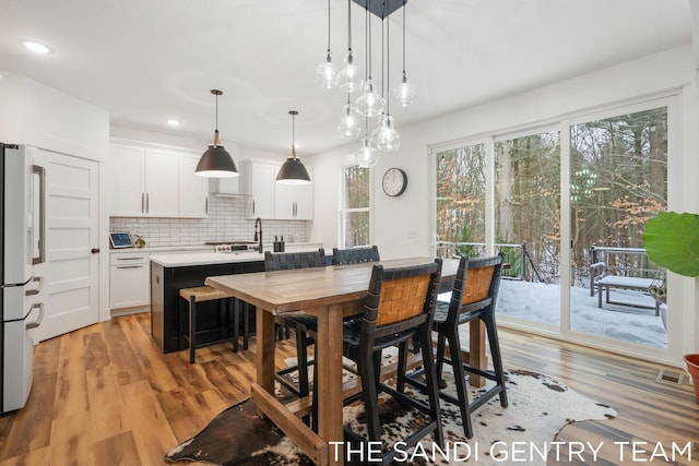 16500 Haven Woods Ct, West Olive, MI 49460 - dining area with light wood-type flooring and recessed lighting