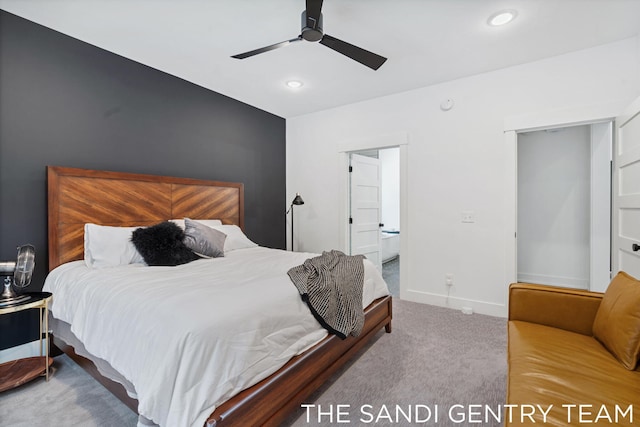 carpeted bedroom with ceiling fan and ensuite bathroom