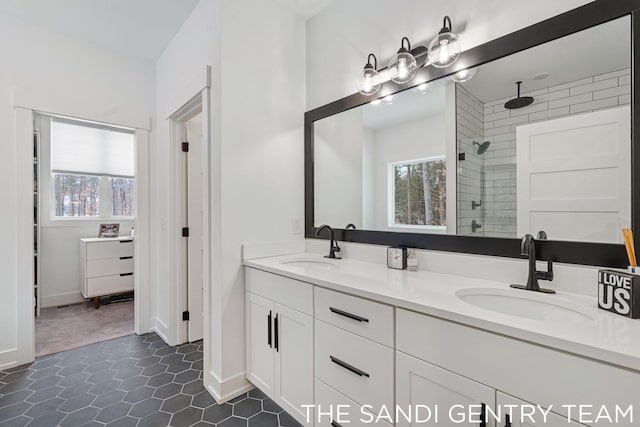 bathroom with vanity and a tile shower