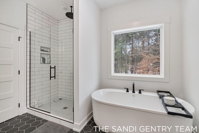 bathroom with tile patterned floors, a wealth of natural light, and plus walk in shower