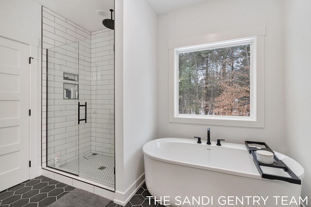 16500 Haven Woods Ct, West Olive, MI 49460 - bathroom featuring a shower stall, a freestanding bath, and tile patterned floors