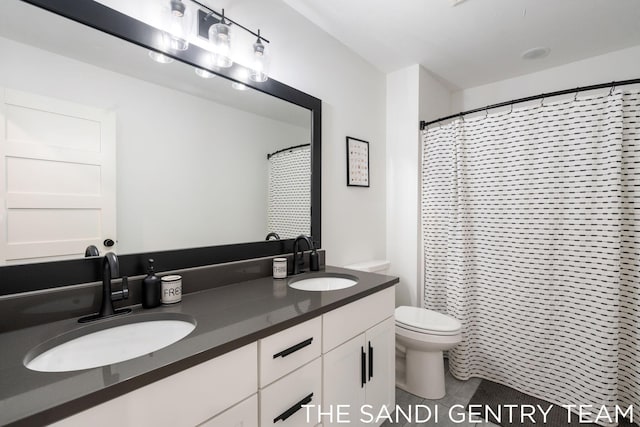 bathroom with vanity, toilet, and walk in shower