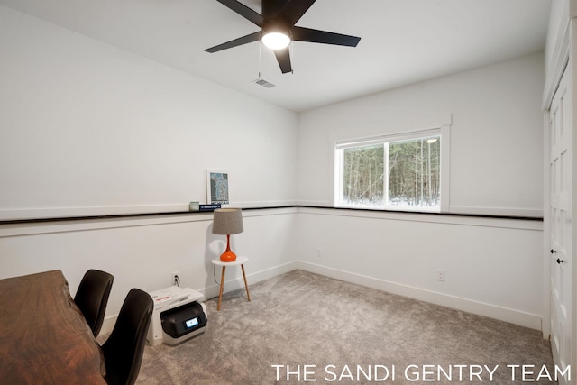 unfurnished office featuring light carpet and ceiling fan