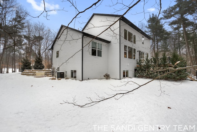 view of snowy exterior with central AC