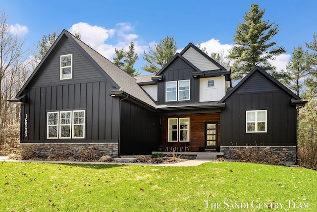 16500 Haven Woods Ct, West Olive, MI 49460 - view of front of home with board and batten siding, stone siding, a porch, and a front yard
