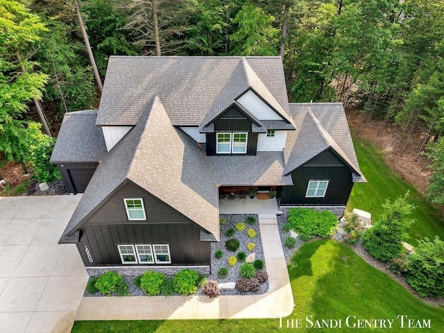 16500 Haven Woods Ct, West Olive, MI 49460 - craftsman house featuring board and batten siding, a shingled roof, a front lawn, driveway, and a garage