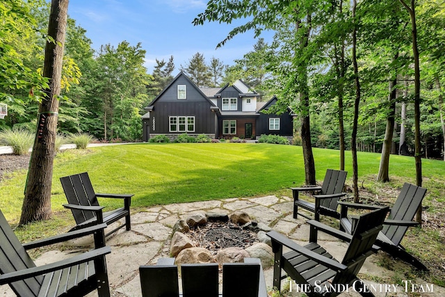16500 Haven Woods Ct, West Olive, MI 49460 - rear view of property with an outdoor fire pit, board and batten siding, and a lawn