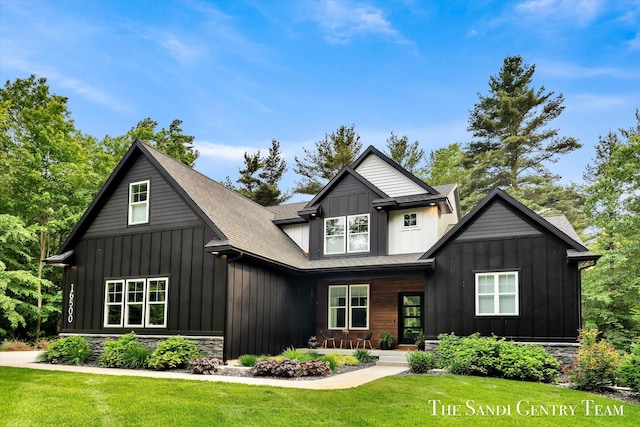 16500 Haven Woods Ct, West Olive, MI 49460 - view of front facade featuring a front lawn, board and batten siding, a porch, and stone siding