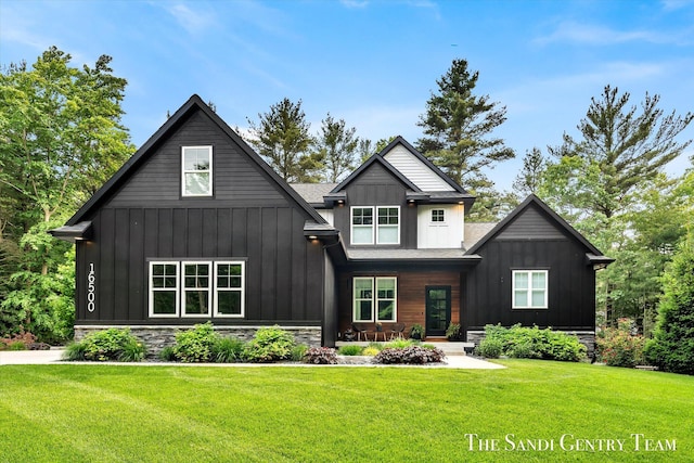 16500 Haven Woods Ct, West Olive, MI 49460 - view of front of home with board and batten siding and a front yard