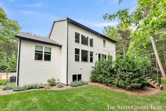 16500 Haven Woods Ct, West Olive, MI 49460 - back of house featuring a lawn and stairway