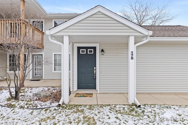 view of snow covered property entrance