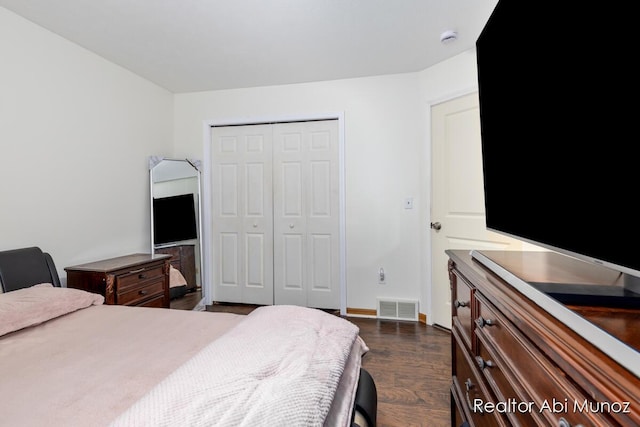 bedroom featuring dark hardwood / wood-style flooring and a closet