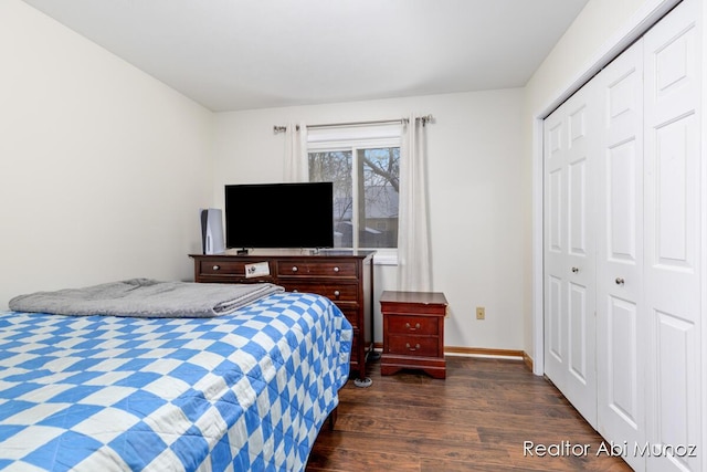 bedroom with a closet and dark hardwood / wood-style floors