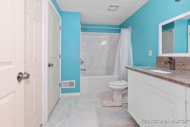 full bathroom featuring shower / bath combination with curtain, vanity, toilet, and a drop ceiling