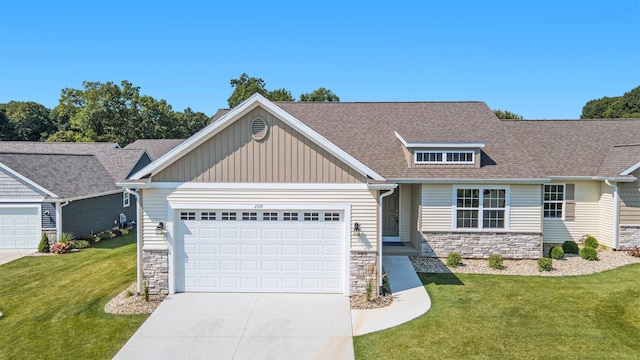 craftsman-style home featuring a front yard and a garage