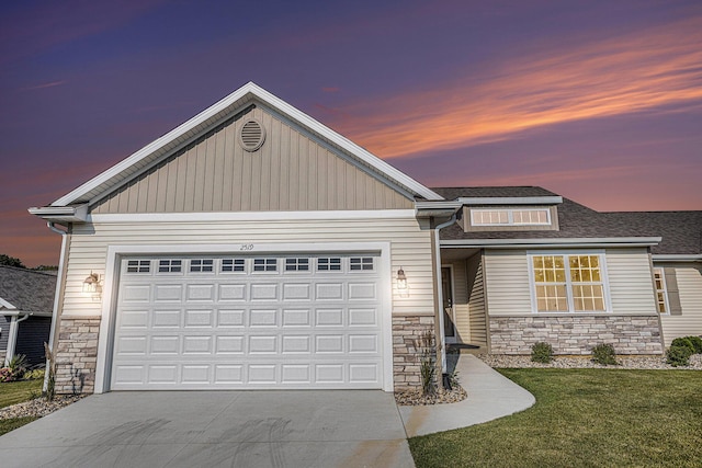 view of front facade featuring a garage and a lawn