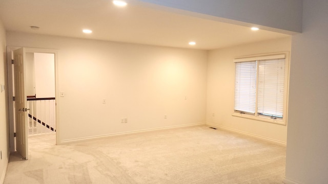 unfurnished room with light colored carpet