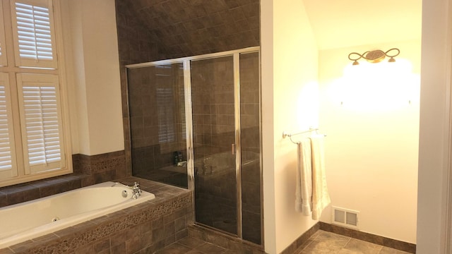 bathroom with shower with separate bathtub, tile patterned floors, and lofted ceiling